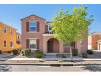 Charming two-story home featuring a well-maintained front yard with tasteful landscaping and neutral color palette at 3535 E Erie St, Gilbert, AZ 85295