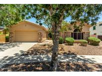 Charming home featuring a desert landscape, stone accents, and a two-car garage with ample parking space at 3715 S Skyline Dr, Gilbert, AZ 85297