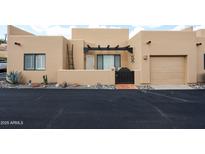 Charming tan stucco home features a private courtyard and attached one car garage at 37222 N Tom Darlington Dr # 15, Carefree, AZ 85377