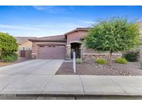 Charming single-story home featuring a low-maintenance landscaped front yard and an attached two-car garage at 3865 E Dogwood Pl, Chandler, AZ 85286