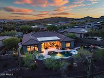 Stunning twilight view of the backyard with private pool and lush desert landscaping at 42429 N Cross Timbers Ct, Anthem, AZ 85086
