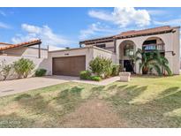 Charming two-story home with a well-manicured lawn and mature landscaping at 7409 E Pleasant Run, Scottsdale, AZ 85258