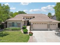 Charming single-story home featuring a well-manicured lawn and a spacious three-car garage at 8664 W Yukon Dr, Peoria, AZ 85382
