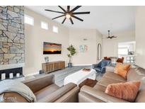 Inviting living room featuring a stone fireplace and neutral-toned furnishings at 11260 N 92Nd St # 2054, Scottsdale, AZ 85260