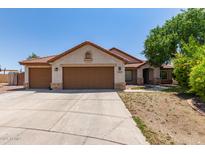 Charming single-story home featuring a terracotta roof, neutral stucco, and a spacious three-car garage at 1443 N Poppy St, Casa Grande, AZ 85122