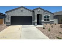 Charming single-story home featuring a two-car garage, stucco exterior, and a well-maintained front yard at 18356 W Gray Fox Trl, Wittmann, AZ 85361