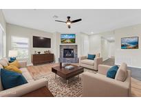 Bright living room features a fireplace with a large screen tv and comfortable seating arrangements at 20121 N 76Th St # 2021, Scottsdale, AZ 85255