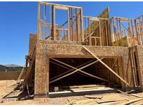 Framing of a new two story home under construction with a two-car garage in a residential area at 21075 N 58Th St, Phoenix, AZ 85054