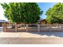 Charming single-story home with mature trees, block fence and low maintenance landscaping at 2110 W Morrow Dr, Phoenix, AZ 85027