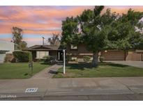 Charming single-Gathering home featuring a well-manicured lawn, mature trees, and traditional architectural design at 2847 S Bala Dr, Tempe, AZ 85282