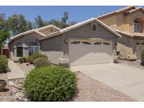 Inviting single-story home with a two-car garage and low maintenance desert landscaping in front at 3114 E Kristal Way, Phoenix, AZ 85050
