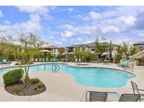 Community pool and lounging area with plenty of seating and lush landscaping at 5100 E Rancho Paloma Dr # 1029, Cave Creek, AZ 85331