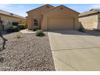 Inviting single-story home featuring a neutral exterior, low-maintenance landscaping, and an attached two-car garage at 5339 W Maldonado Rd, Laveen, AZ 85339