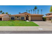 Charming single-story home with a well-maintained lawn and a two-car garage at 5507 E Kings Ave, Scottsdale, AZ 85254