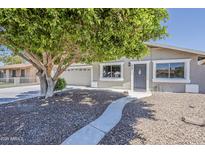 Charming single-story home with a desert landscape and a mature shade tree in the front yard at 662 W Elena Ave, Mesa, AZ 85210