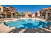 Community pool offers a place to relax and enjoy the outdoors with lovely nearby buildings at 700 E Mesquite Cir # J135, Tempe, AZ 85288