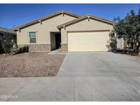Charming single-story home featuring a two-car garage and low maintenance desert landscaping at 7321 N 123Rd Dr, Glendale, AZ 85307