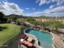 Inviting backyard pool and patio area offers mountain views, perfect for relaxation and outdoor enjoyment at 7398 W Paso Trl, Peoria, AZ 85383
