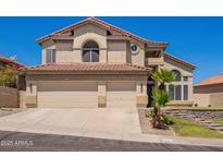Charming two-story home featuring a three-car garage and well-maintained landscaping at 818 E Hiddenview Dr, Phoenix, AZ 85048