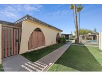 Charming condo with unique arched entryway and landscaped walkway leading to a refreshing community pool at 830 S Dobson Rd # 19, Mesa, AZ 85202
