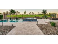 Inviting pool and spa area with blue tiled accents and beautiful desert view at 11534 N Jerome St, Surprise, AZ 85388