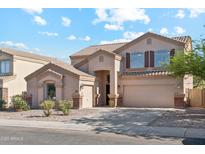Charming two-story home with a three car garage, tan exterior, and well-manicured landscaping at 1239 W Descanso Canyon Dr, Casa Grande, AZ 85122