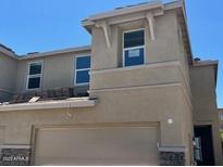 Inviting exterior of a two-story home with a neutral color scheme, stone accents, and a convenient garage at 21228 N 58Th St, Phoenix, AZ 85054