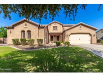 Charming two-story home features a manicured front yard and a spacious two-car garage at 21605 S 187Th Way, Queen Creek, AZ 85142
