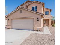 Charming two-story home featuring a neutral color palette, a two-car garage, and a well-maintained front yard at 22328 W Woodlands Ave, Buckeye, AZ 85326