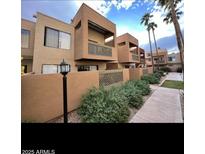 A view of the condo's exterior, showing the unique architecture and well-maintained landscaping at 3500 N Hayden Rd # 203, Scottsdale, AZ 85251