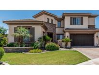 Elegant two-story home featuring well-manicured lawn, desert landscaping, and a brick accent wall at 4463 S Oregon Ct, Chandler, AZ 85248