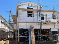 New home under construction, showcasing the exterior framing and scaffolding at 5819 E Covey Ln, Phoenix, AZ 85054