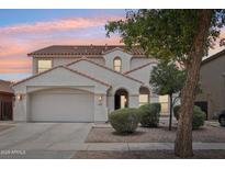 Charming two-story home with a well-maintained front yard, a neutral color scheme, and a terracotta tile roof at 11158 N 162Nd Dr, Surprise, AZ 85379