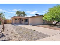 Single story home featuring a brick facade, covered patio, and desert landscaping in front at 12201 N 22Nd Pl, Phoenix, AZ 85022