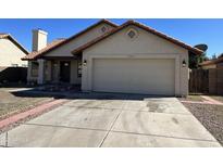 Charming single-story home with a two-car garage, manicured lawn, and inviting curb appeal at 15801 W Meade Ln, Goodyear, AZ 85338