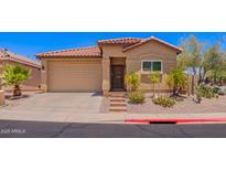 Charming single-story home with a desert-landscaped front yard and a red tile roof at 1702 W Amberwood Dr, Phoenix, AZ 85045