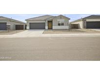 Charming single-story home featuring a gray color scheme, a two-car garage and minimalist landscaping at 17743 W Onyx Ave, Waddell, AZ 85355