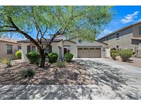 Charming single-story home with a well-manicured lawn, mature landscaping, and a two-car garage in a desirable neighborhood at 17966 W Agave Rd, Goodyear, AZ 85338