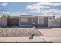 Cozy single-story home featuring a minimalist front yard with a unique mailbox and covered entry at 2103 N Silverton St, Mesa, AZ 85203