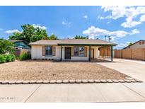 Charming single-story home with a cozy carport and a low maintenance desert landscape at 2215 W Straford Dr, Chandler, AZ 85224