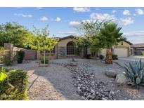 Charming single-story home with desert landscaping, river rock features, and a stone facade at 2830 S Riata Ct, Gilbert, AZ 85295