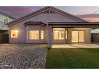 Home backyard featuring a patio, gravel landscaping, and a small patch of artificial turf at 689 E Stottler Dr, Gilbert, AZ 85296