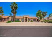 Charming home featuring a tile roof, mature landscaping and desert landscaping for low maintenance at 7722 W Libby St, Glendale, AZ 85308
