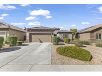 Charming single-story home featuring a well-maintained landscape and a two-car garage at 10749 W Lariat Ln, Peoria, AZ 85383