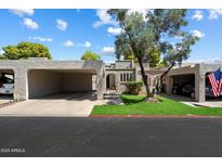 Charming home featuring dual carports, manicured lawn, and decorative stucco exterior at 1120 E Beryl Ave, Phoenix, AZ 85020