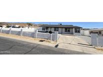 Charming single-story home featuring black trim, a concrete driveway, and a low-walled front yard at 121 E Monte Way, Phoenix, AZ 85042