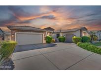 Beautiful single-Gathering home with a well manicured front yard and multi-car garage under a colorful sunset at 1410 S Los Altos Dr, Chandler, AZ 85286
