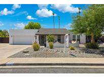 Charming single-story home featuring desert landscaping and a bright exterior under a clear blue sky at 1452 E Gary St, Mesa, AZ 85203