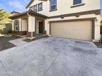 Inviting home exterior showcases a two-car garage and manicured landscaping at 16236 W La Ventilla Way, Goodyear, AZ 85338