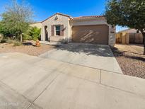 Charming single-story home with a well-maintained front yard, desert landscaping, and a two-car garage at 19904 W Sherman St, Buckeye, AZ 85326